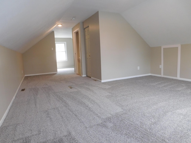 bonus room featuring baseboards, carpet, and vaulted ceiling