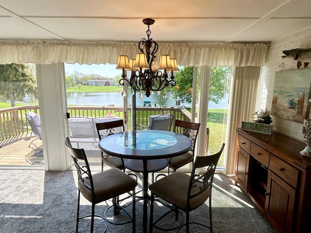 26955 Milford Rd Unit 20, South Lyon, MI 48178 - dining room with a water view, dark carpet, a healthy amount of sunlight, and an inviting chandelier