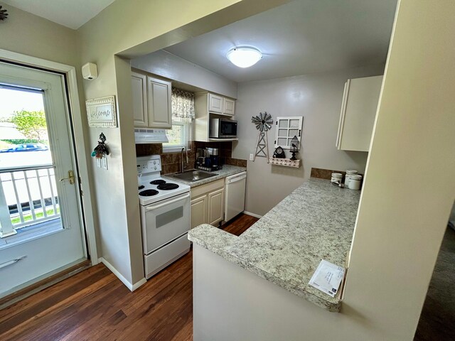 26955 Milford Rd Unit 20, South Lyon, MI 48178 - kitchen with dark wood-style floors, white appliances, a healthy amount of sunlight, and a sink