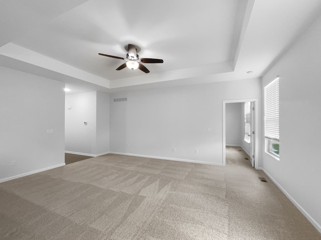 8351 Ardmoor Dr, Ypsilanti, MI 48198 - spare room featuring a ceiling fan, a raised ceiling, visible vents, and light colored carpet