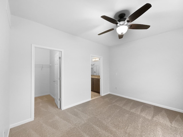 8351 Ardmoor Dr, Ypsilanti, MI 48198 - unfurnished bedroom featuring baseboards, a closet, light colored carpet, and a walk in closet