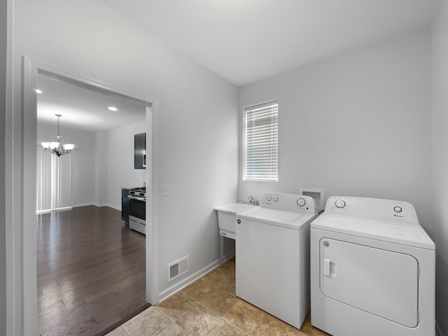 8351 Ardmoor Dr, Ypsilanti, MI 48198 - laundry area with washing machine and dryer, baseboards, visible vents, a chandelier, and laundry area