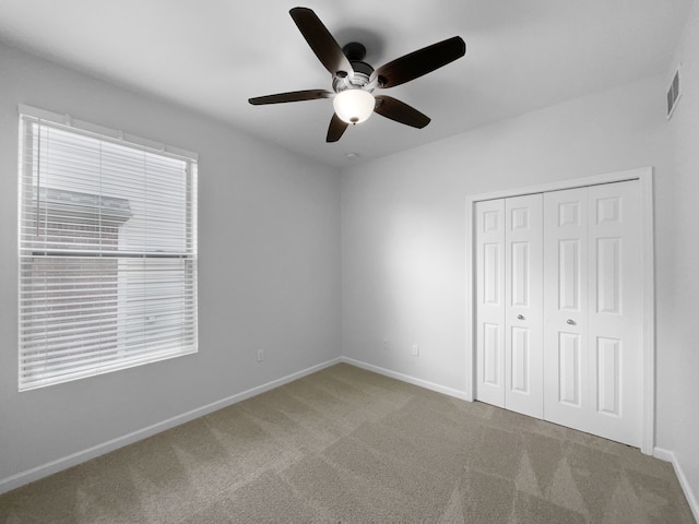 8351 Ardmoor Dr, Ypsilanti, MI 48198 - unfurnished bedroom with a ceiling fan, a closet, baseboards, carpet flooring, and visible vents