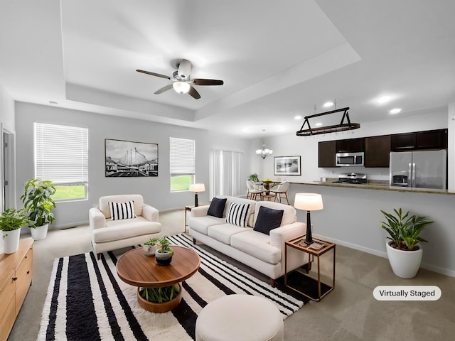 8351 Ardmoor Dr, Ypsilanti, MI 48198 - living area featuring a raised ceiling, light colored carpet, a chandelier, a ceiling fan, and recessed lighting