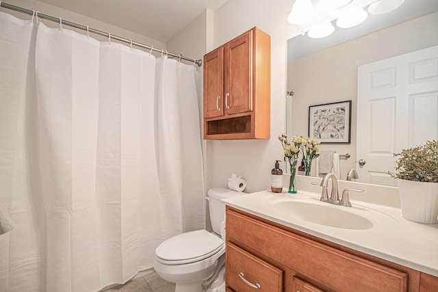 full bath featuring vanity, toilet, and tile patterned flooring