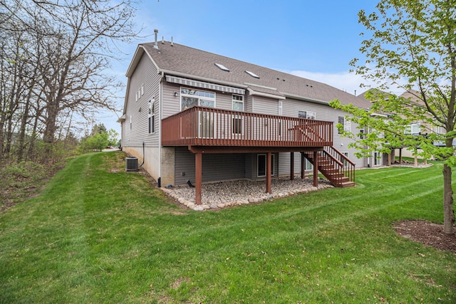 rear view of property with stairway, a deck, a shingled roof, and a yard