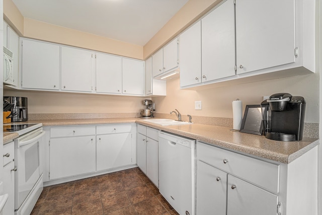 kitchen featuring stone finish flooring, a sink, white cabinets, white appliances, and light countertops