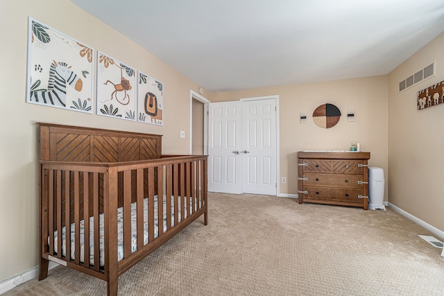 carpeted bedroom with baseboards, a closet, and visible vents