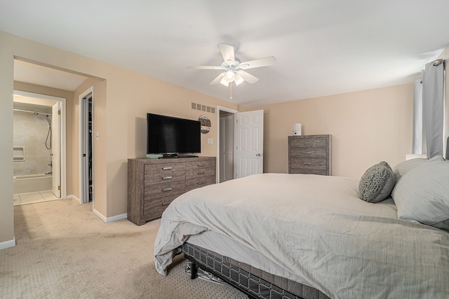 bedroom with connected bathroom, visible vents, baseboards, ceiling fan, and light carpet