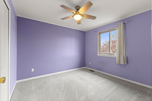 empty room with a ceiling fan, carpet flooring, and baseboards