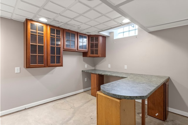 kitchen with concrete floors, glass insert cabinets, baseboards, and recessed lighting