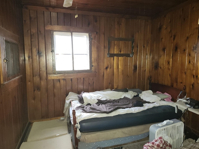 bedroom featuring wood walls