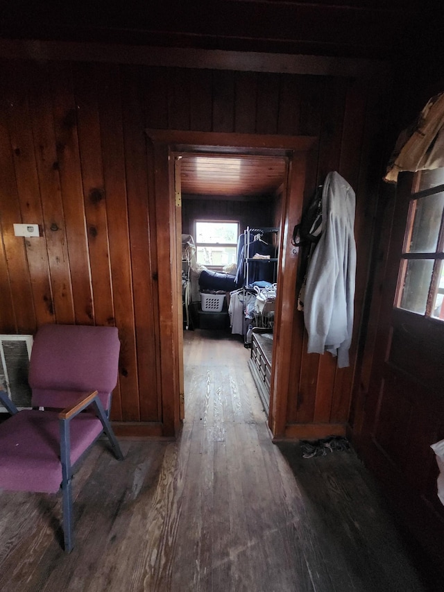 hall featuring hardwood / wood-style flooring and wood walls