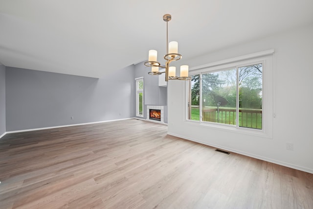 29513 Sierra Pointe Cir, Farmington Hills, MI 48331 - unfurnished living room with light wood finished floors, baseboards, a chandelier, and a fireplace