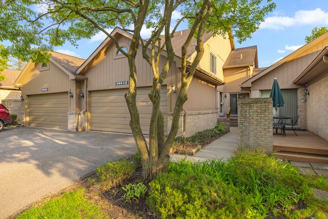 29513 Sierra Pointe Cir, Farmington Hills, MI 48331 - townhome / multi-family property with brick siding, asphalt driveway, an attached garage, and roof with shingles