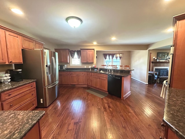 kitchen featuring a peninsula, stainless steel fridge with ice dispenser, dark wood-style floors, and dishwasher