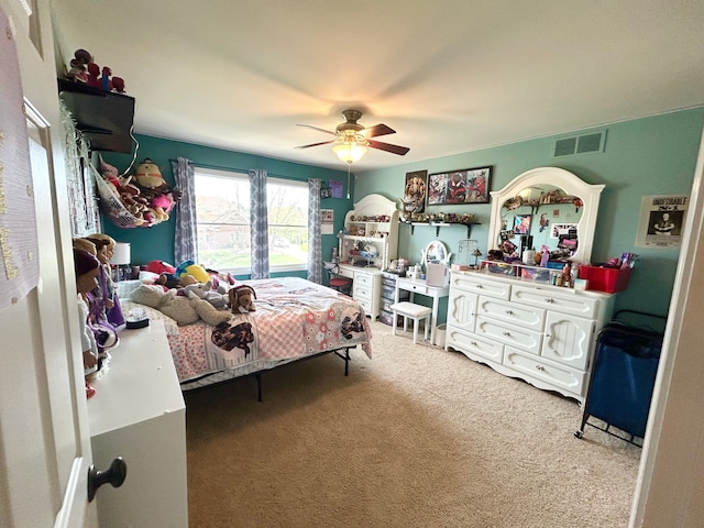 carpeted bedroom featuring visible vents and ceiling fan