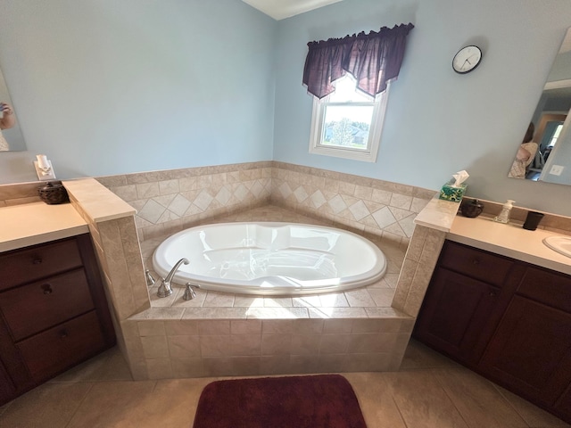full bath with tile patterned flooring, a bath, and vanity