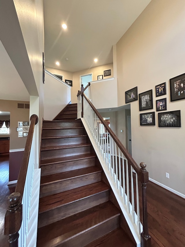 stairs featuring baseboards, recessed lighting, visible vents, and wood finished floors