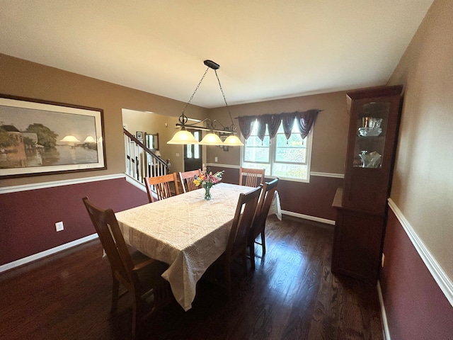dining room with baseboards and wood finished floors
