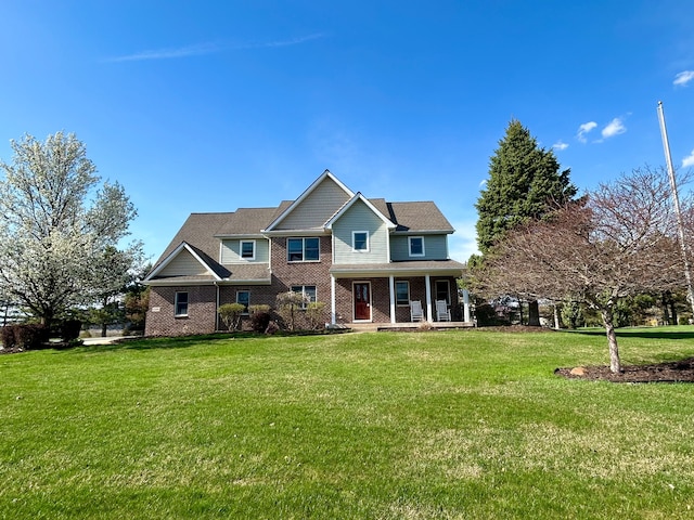 view of front of house featuring a front lawn, a porch, and brick siding