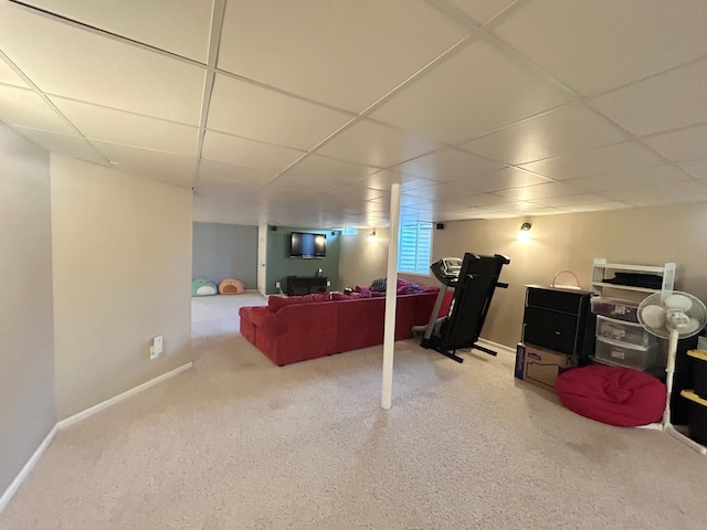 below grade area with carpet, a drop ceiling, and baseboards
