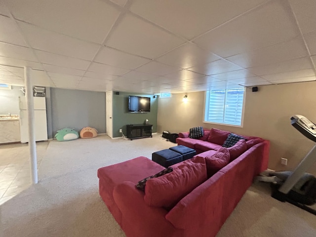living room featuring a paneled ceiling and carpet flooring