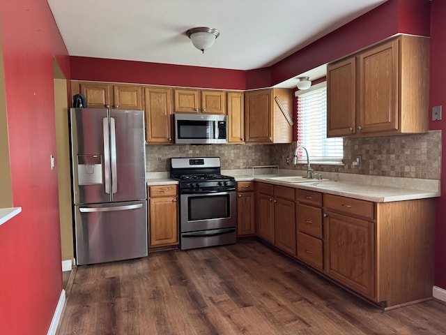 31534 Stricker Dr, Warren, MI 48088 - kitchen with appliances with stainless steel finishes, a sink, light countertops, dark wood-style flooring, and brown cabinetry