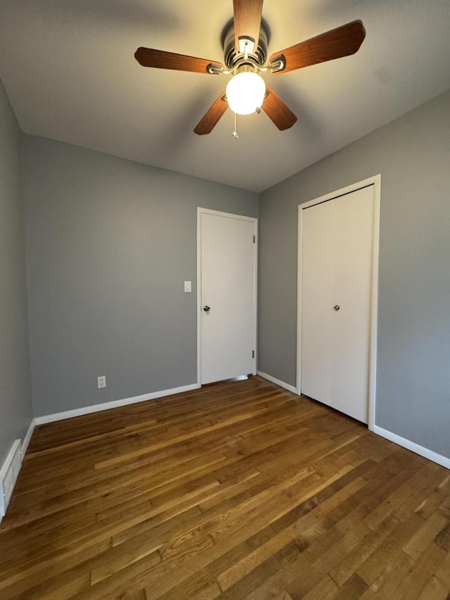 31534 Stricker Dr, Warren, MI 48088 - unfurnished bedroom featuring baseboards, wood finished floors, ceiling fan, and a closet