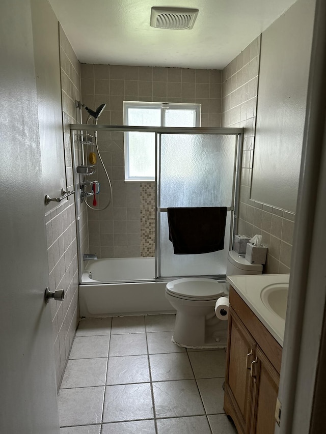 31534 Stricker Dr, Warren, MI 48088 - full bath with vanity, shower / bath combination with glass door, toilet, tile patterned flooring, and tile walls