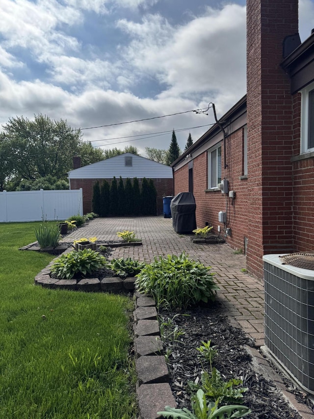 31534 Stricker Dr, Warren, MI 48088 - view of yard with central AC and a patio area