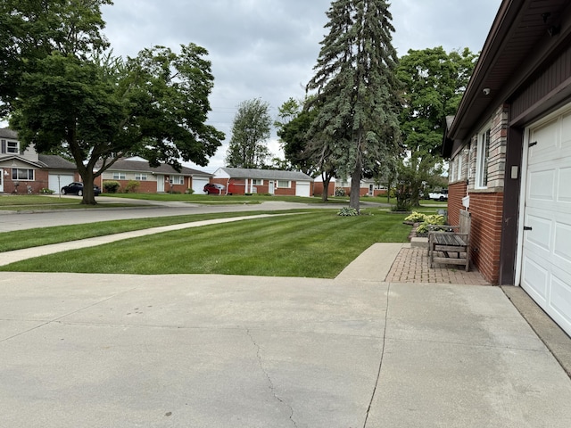 31534 Stricker Dr, Warren, MI 48088 - view of green lawn with a garage and a residential view