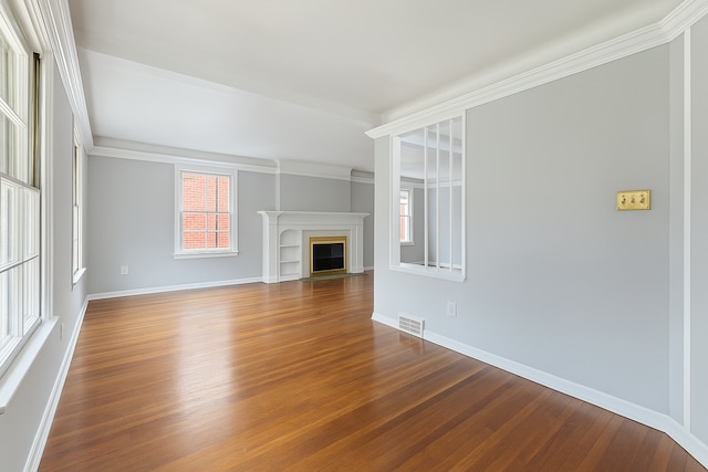 16760 Greenview Ave, Detroit, MI 48219 - unfurnished living room featuring a wealth of natural light, baseboards, visible vents, and wood finished floors