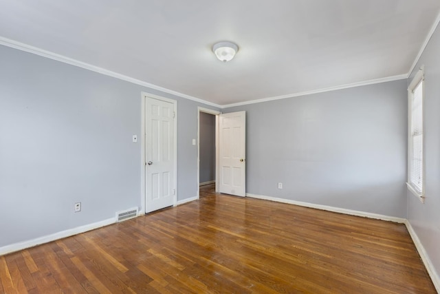 16760 Greenview Ave, Detroit, MI 48219 - spare room with wood finished floors, visible vents, baseboards, and ornamental molding