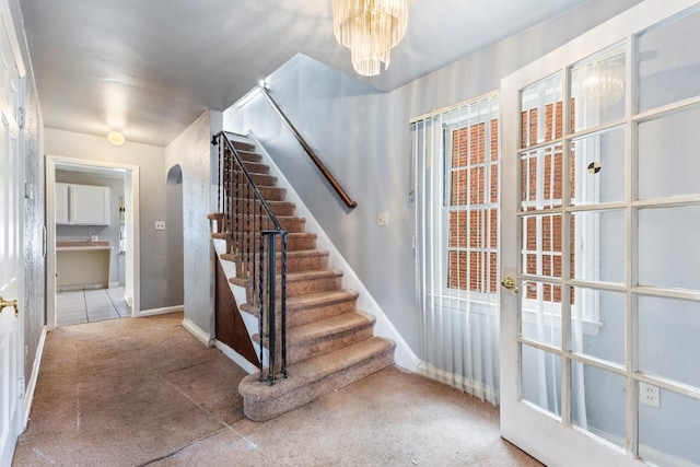 16760 Greenview Ave, Detroit, MI 48219 - staircase featuring a chandelier and baseboards