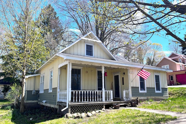 bungalow-style home featuring board and batten siding, a porch, and a front yard