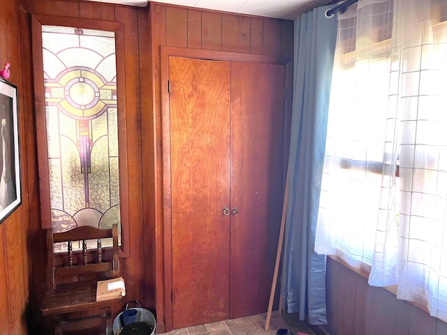 doorway featuring wooden walls and a healthy amount of sunlight
