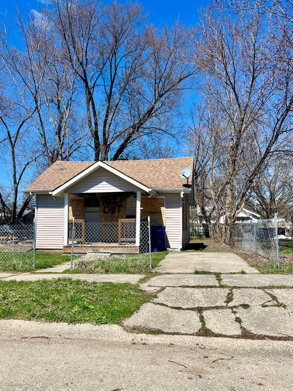 exterior space featuring covered porch, a shingled roof, and fence private yard