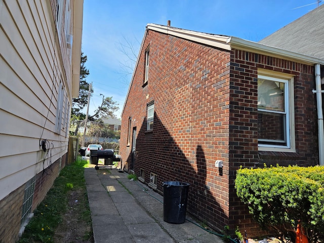 view of side of property with brick siding