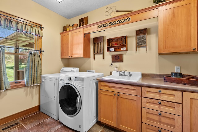 12324 Cranes Ave, Richland, MI 49083 - laundry area featuring a sink, cabinet space, a textured ceiling, washer and clothes dryer, and visible vents