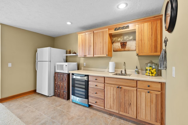 12324 Cranes Ave, Richland, MI 49083 - kitchen with a textured ceiling, beverage cooler, white appliances, a sink, and light countertops