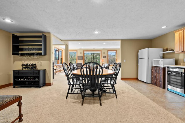 12324 Cranes Ave, Richland, MI 49083 - dining room featuring beverage cooler, a textured ceiling, and baseboards