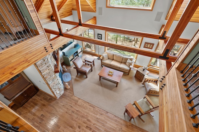 12324 Cranes Ave, Richland, MI 49083 - living room with stairs, visible vents, a high ceiling, and wood finished floors