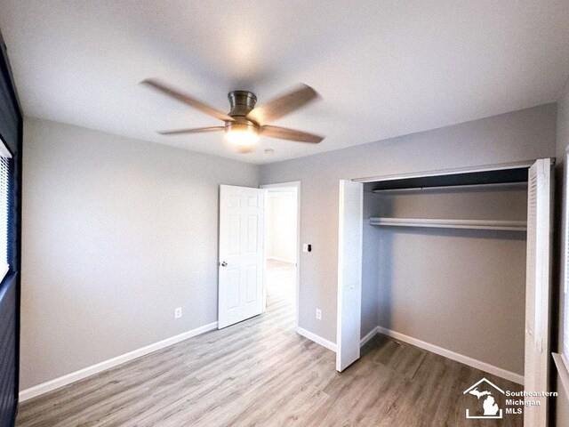 35381 Dern Dr, Rockwood, MI 48173 - unfurnished bedroom with a closet, baseboards, wood finished floors, and a ceiling fan