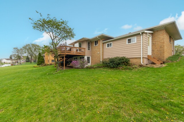 3928 Embarcadero St, Waterford, MI 48329 - back of property featuring a deck, a lawn, brick siding, and entry steps