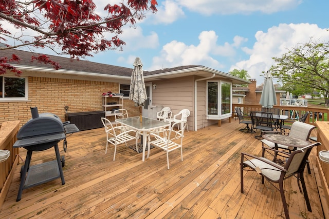 3928 Embarcadero St, Waterford, MI 48329 - wooden terrace with outdoor dining space and a grill