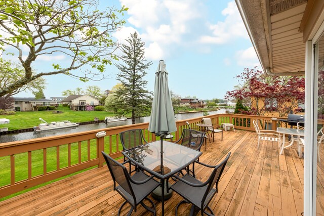 3928 Embarcadero St, Waterford, MI 48329 - wooden deck with outdoor dining space, a water view, and a yard