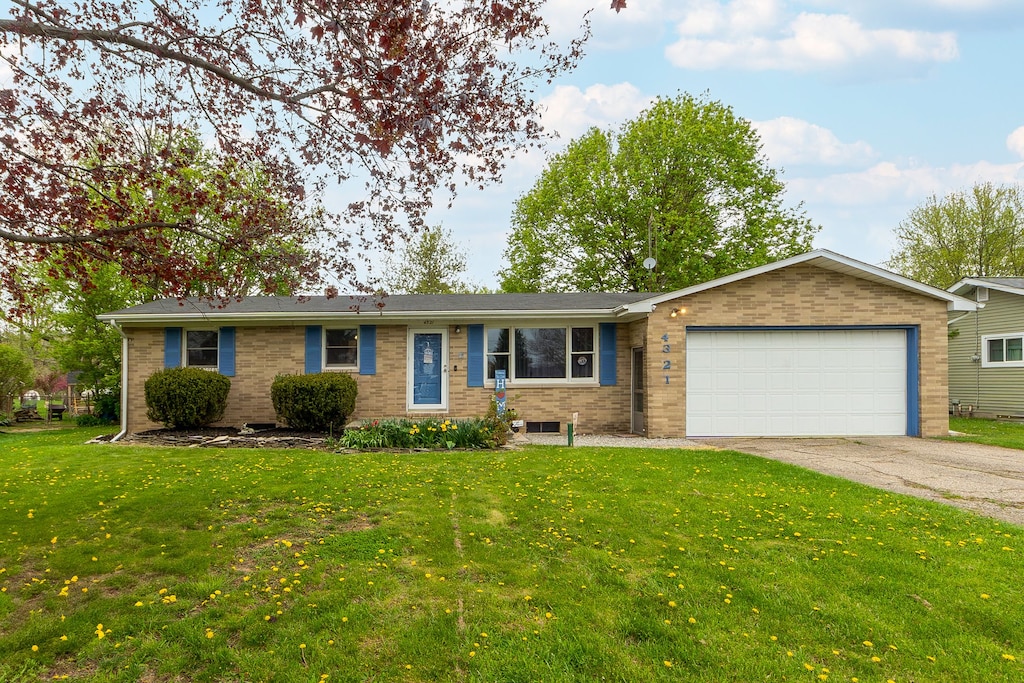4321 Esta Dr, Genesee, MI 48506 - ranch-style house with brick siding, an attached garage, concrete driveway, and a front lawn