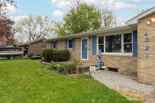 single story home featuring a front lawn and brick siding