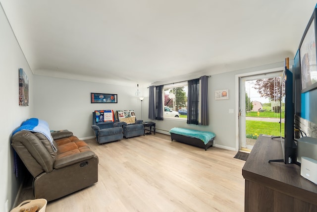 living area featuring light wood-style flooring and baseboards